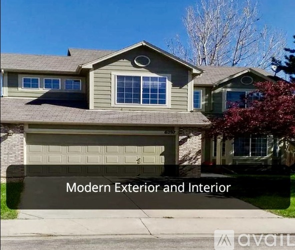 A modern house with a grey exterior and a garage door.