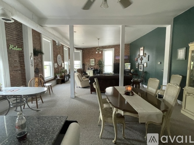 A dining room with a table set for six.