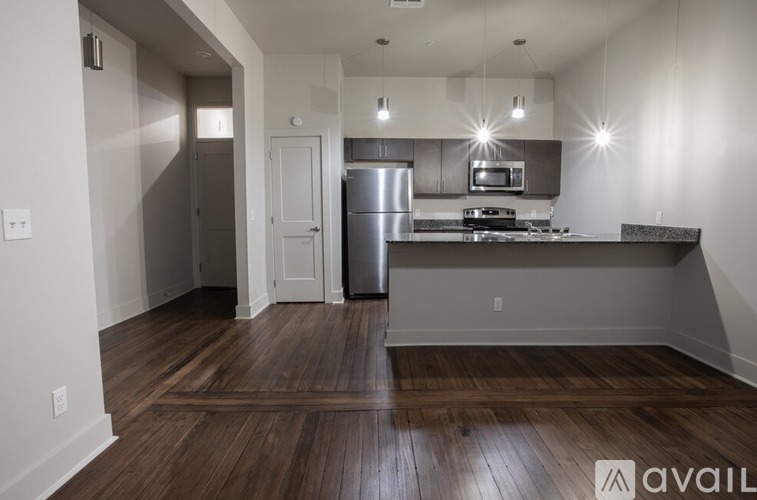 A kitchen with a refrigerator, microwave, and oven is available for rent.
