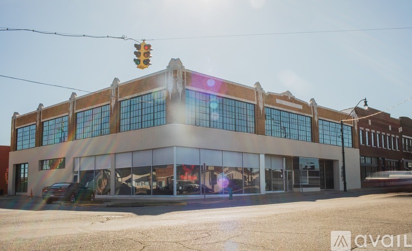 A street view of a building with a traffic light above it.