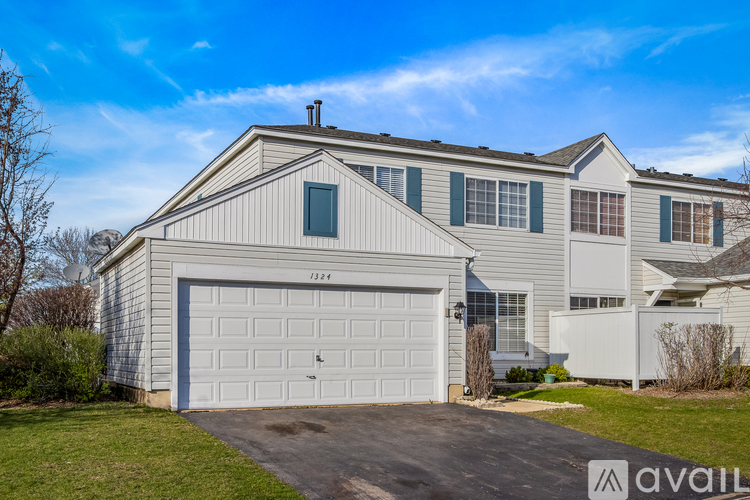A two-story house with a garage is available for rent.