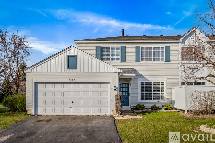 A two-story house with a garage is for sale.