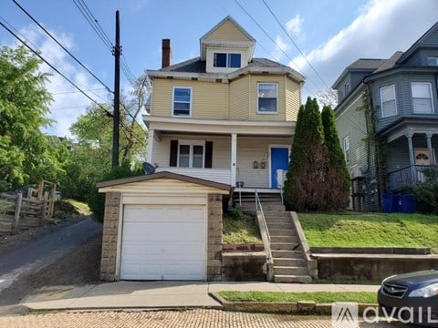 A two-story house with a garage is for sale.