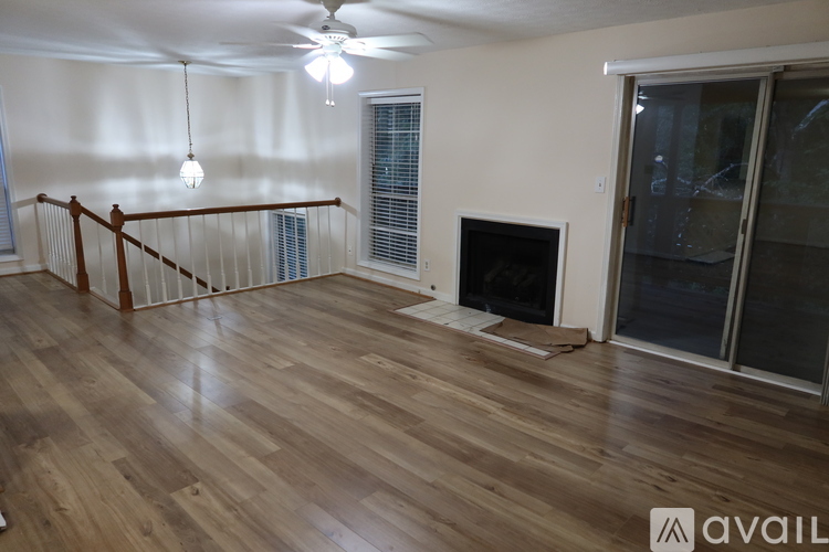 A living room with a fireplace and a balcony.