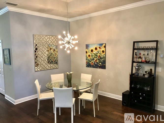 A dining room with a glass table and chairs.