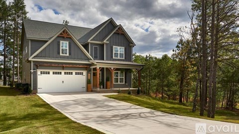 A house with a grey roof and a white garage door.