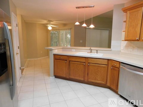 A kitchen with wooden cabinets and a white countertop.