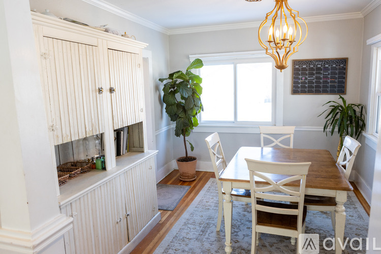 A dining room with a wooden table and chairs.