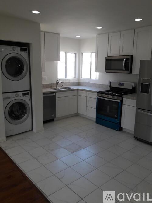 A kitchen with a washing machine and a dishwasher.