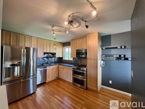 A kitchen with wooden cabinets and stainless steel appliances.
