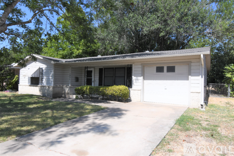 A two-car garage is located in a grassy area.