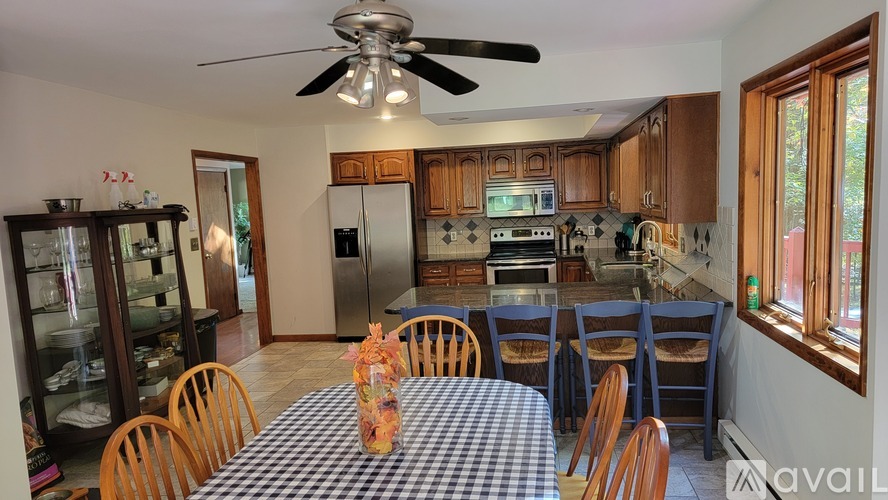 A kitchen with a table and chairs in the middle of the room.