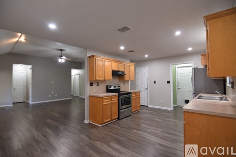 A kitchen with wooden cabinets and a countertop is available for rent.