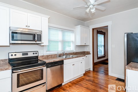 A kitchen with white cabinets and stainless steel appliances.