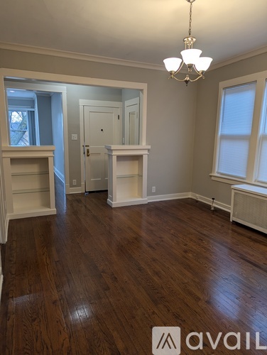 A room with wooden floors and a chandelier.