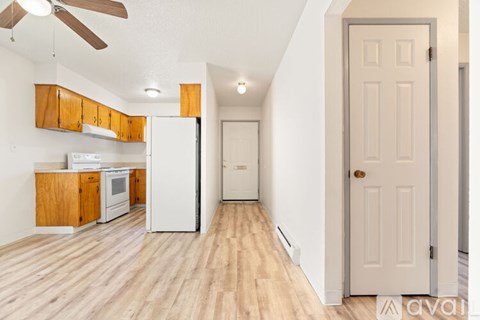 A room with wooden flooring and a ceiling fan.