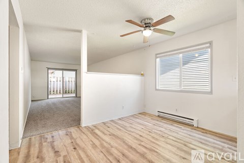 A room with a window and a wall-mounted air conditioner unit.