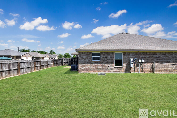 A house with a fence and a grassy yard.