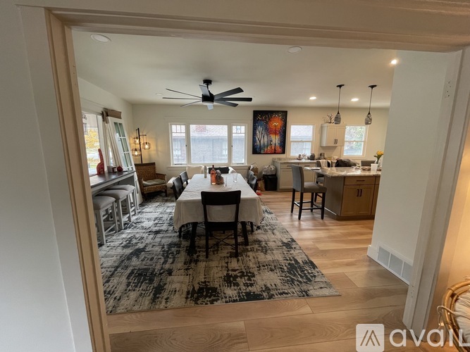 A dining room with a table set for six people.