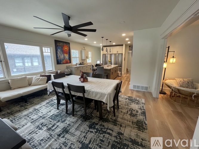 A living room with a dining table set up with chairs around it.