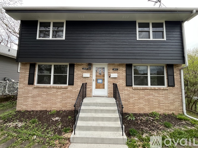 A house with a black roof and a brown door.