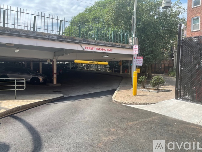 A parking garage entrance with a sign that says "PERMIT PARKING ONLY".