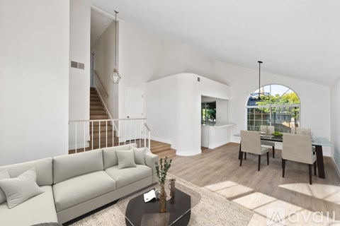 A living room with a white couch and a coffee table.