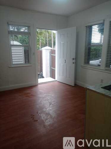A room with a white door and a window with blinds.