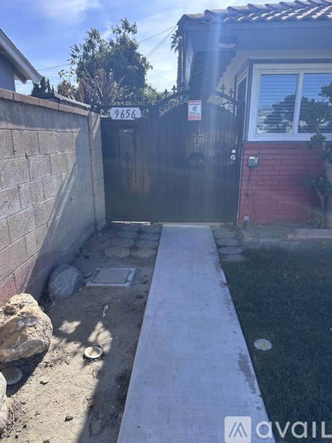 A black gate with the number 9656 on it.