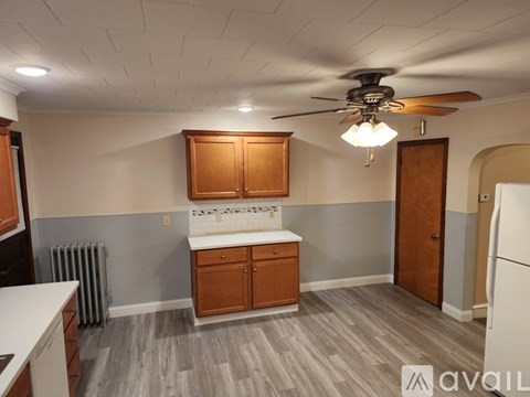 A kitchen with wooden cabinets and a white countertop.