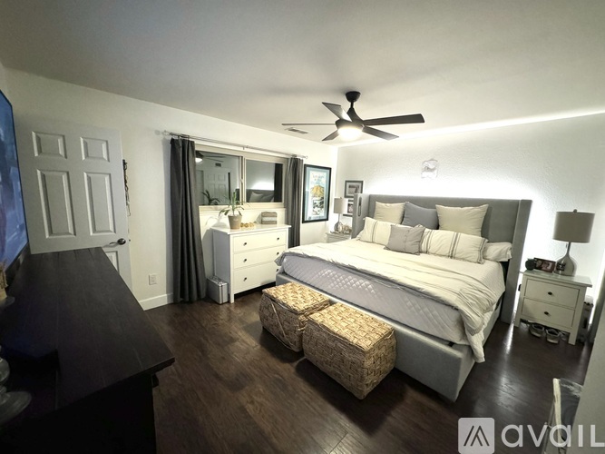 A bedroom with a large bed and a smaller bed in the corner.