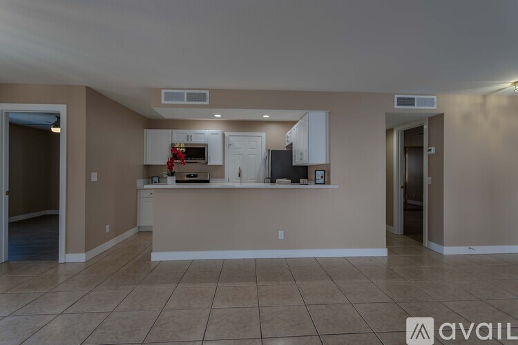 A kitchen area with a counter and cabinets.
