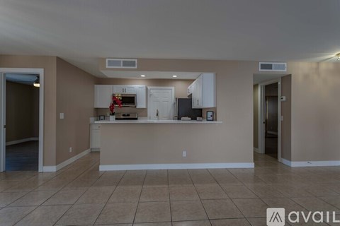 A kitchen area with a counter and cabinets.