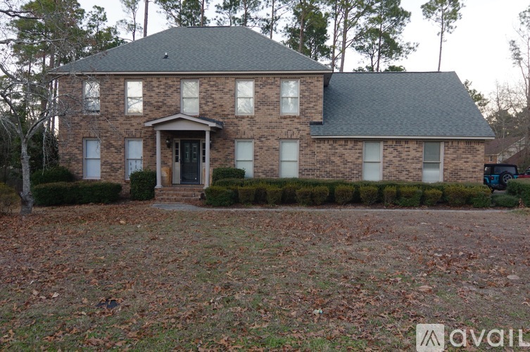 A brick house with a black door and windows.