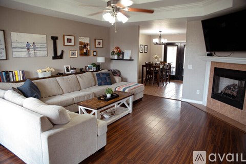 A living room with a white couch and a fireplace.