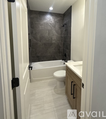 A bathroom with a toilet, sink, and bathtub.