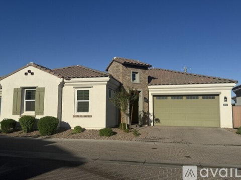 A house with a garage and a driveway in front.