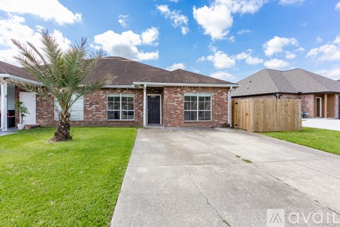 A house with a brick facade and a wooden garage door.
