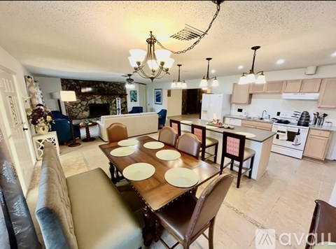 A dining room with a table set for six.