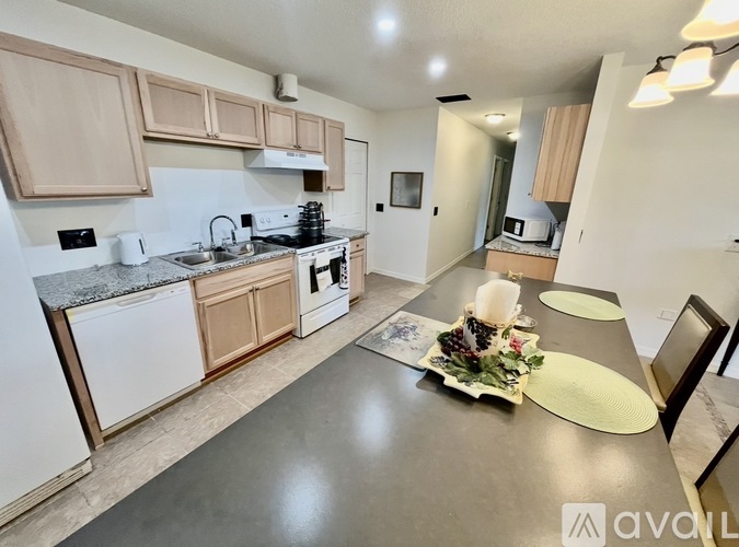 A kitchen with a table set for a meal.
