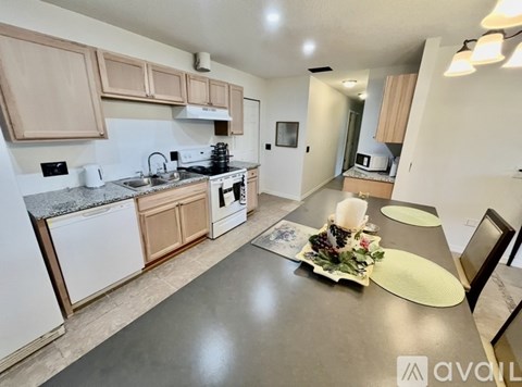 A kitchen with a table set for a meal.