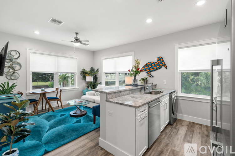 A modern kitchen with a blue rug on the floor.