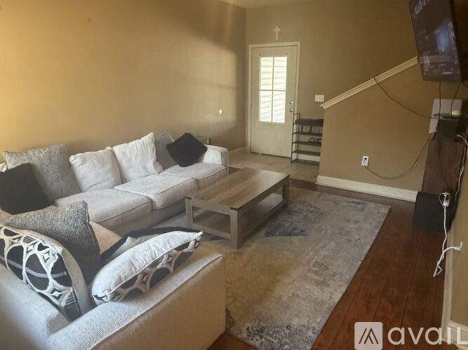 A living room with a grey couch and a coffee table.