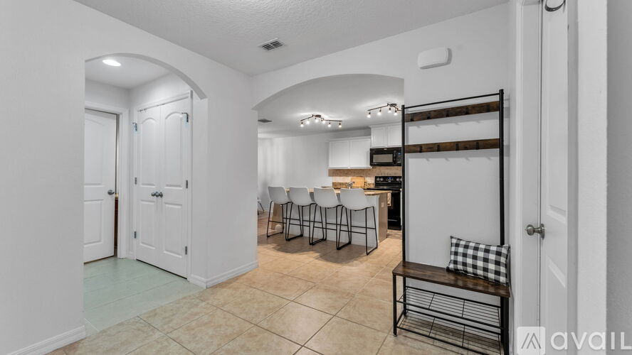 A kitchen area with a bench and a dining table with chairs.