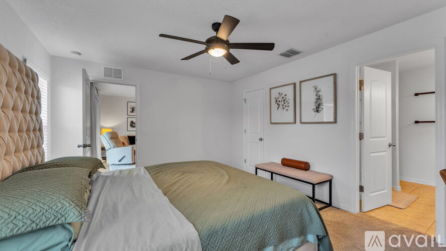 A bedroom with a bed covered in a blue and white striped comforter.