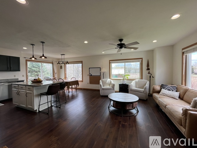 A living room with a kitchen area in the background.
