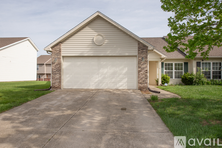 A house with a garage door and a driveway.