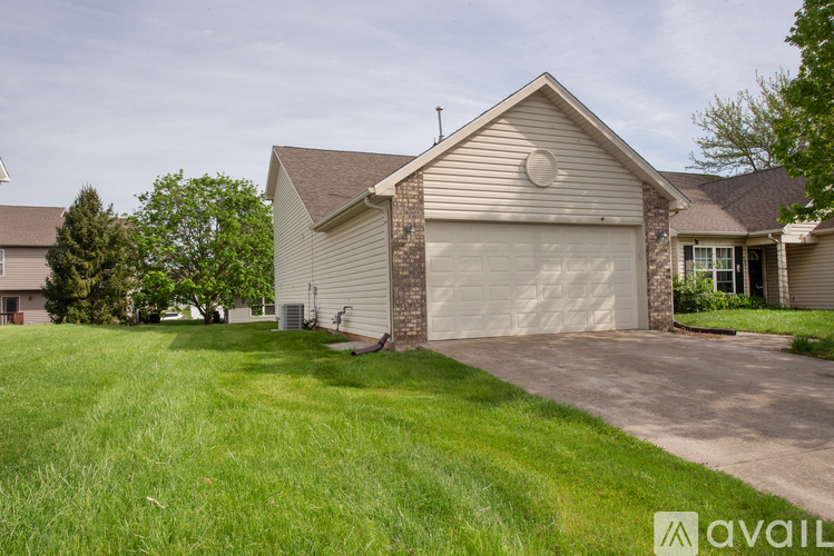 A house with a garage and a driveway in front.