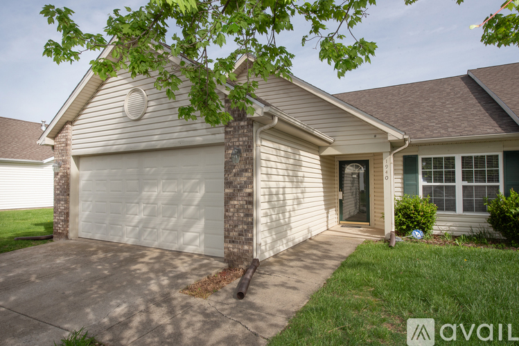 A house with a white garage door and a brown roof.