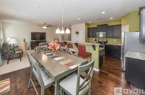 A kitchen with a table and chairs in the middle of the room.